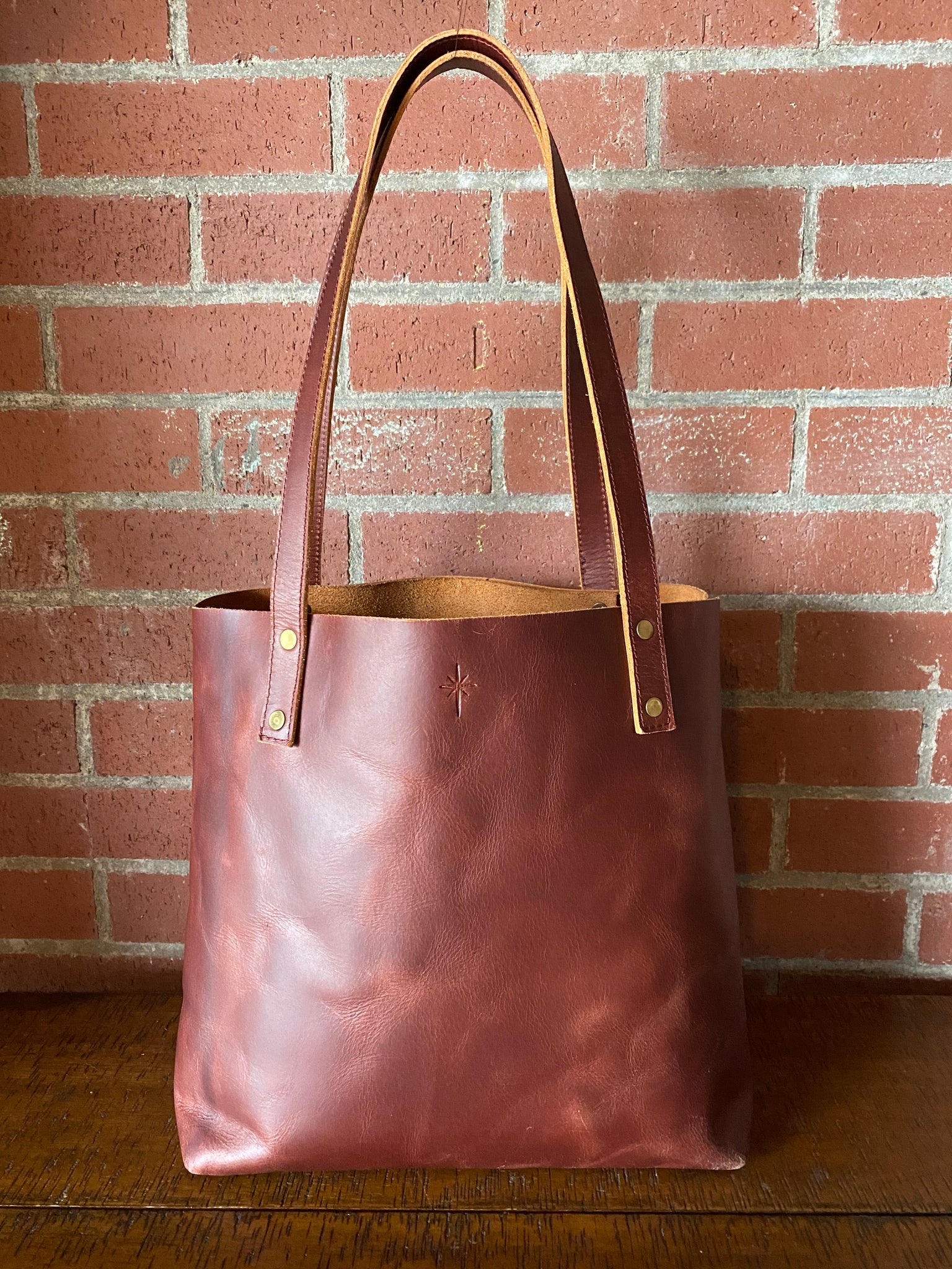 Brown leather tote back with 10.5 inch drop handles with two straps
